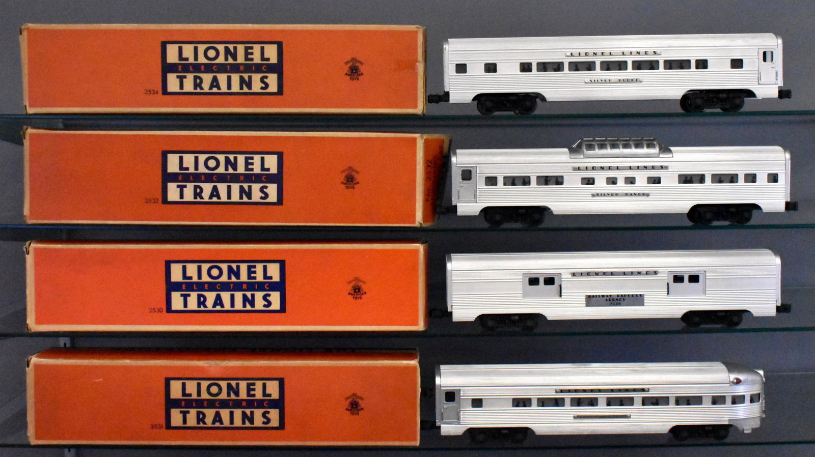 Lionel postwar O gauge extruded aluminum passenger car: This is a matching set with all hex head screws holding the name plates down except for the baggage which are always glued. Cars have moderate run time but are C6-7 with mostly complete original boxes