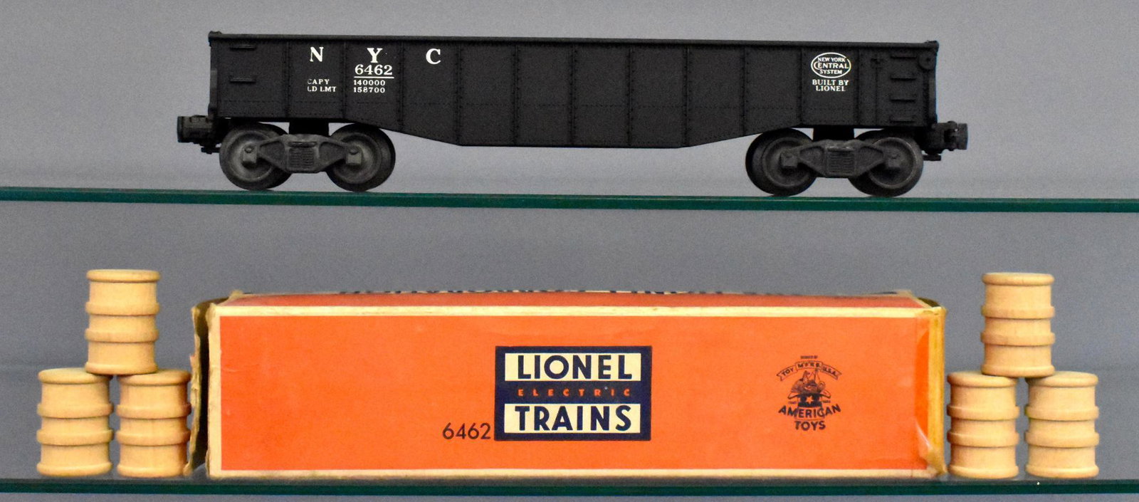 Mint Lionel postwar O gauge 6462 black gondola in: Black New York Central gondola is unrun, comes with barrels and original inspection slip in an incomplete original box.