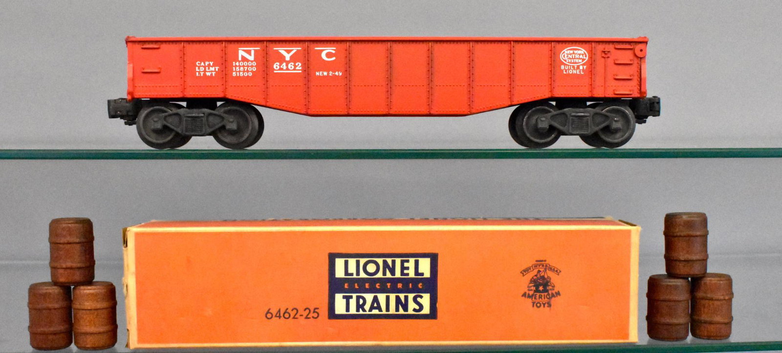 Unrun Lionel postwar O gauge 6462-25 red painted: Car is unrun with some box rubs along the top edges, otherwise C8 with six wooden barrels and an original inspection slip with an excellent original box.