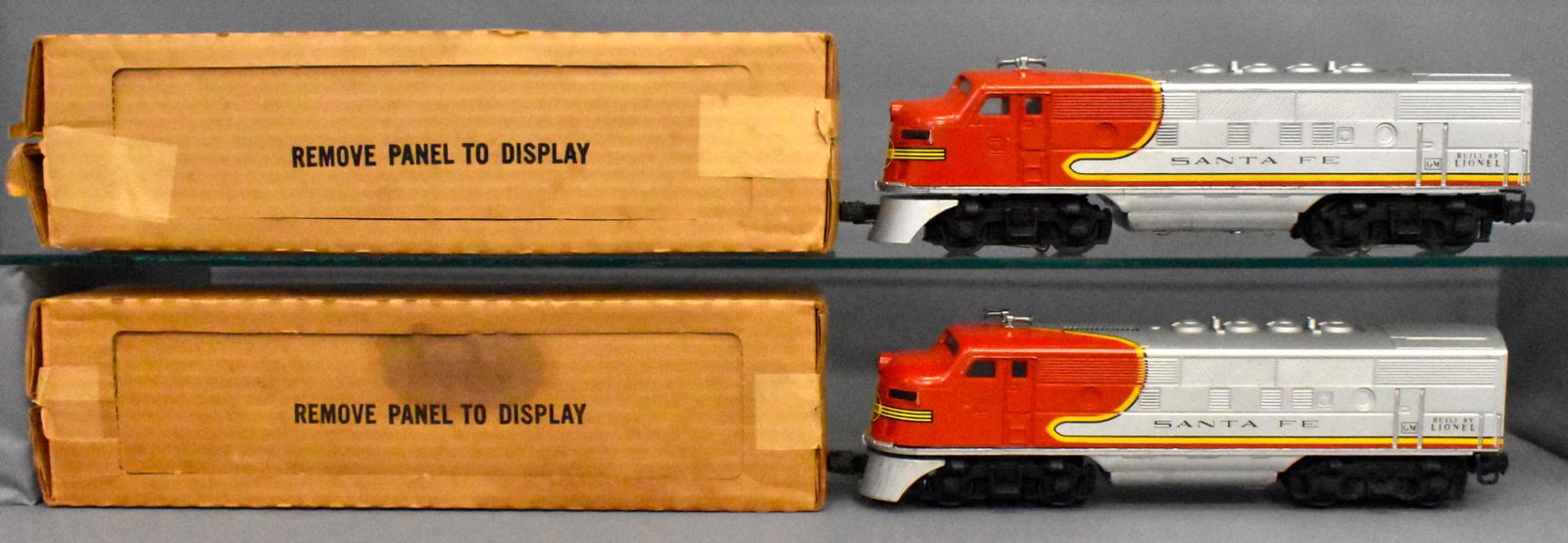 Lionel postwar O gauge 2383 Santa Fe F-3 AA set in: Powered unit shows considerable run time with loss of silver from belly pan and a rub on the roofnext to the vent but no battery damage. The dummy unit looks much nicer but does show cracking to the n