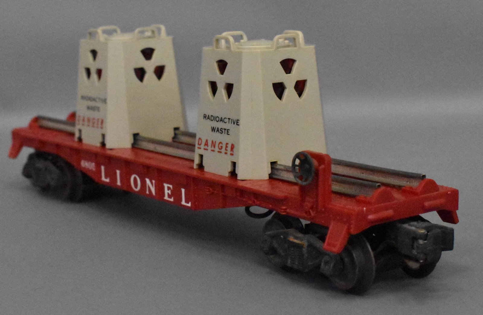 Lionel postwar O gauge 6805 atomic waste disposal flat: Car shows light run time and has very nice lettering on bost sides with two undamaged original canisters, C7.