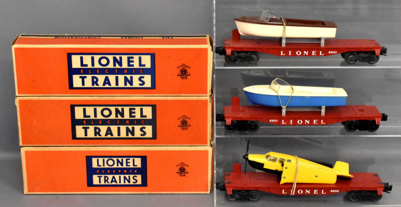 Lionel postwar O gauge airplane and boat flat cars in: Includes 6800 airplane flat car with original Beechcraft Bonanza airplane and two 6801 flat cars with original boats (one blue and one brown), C7 with light run time and three very good to excellent o