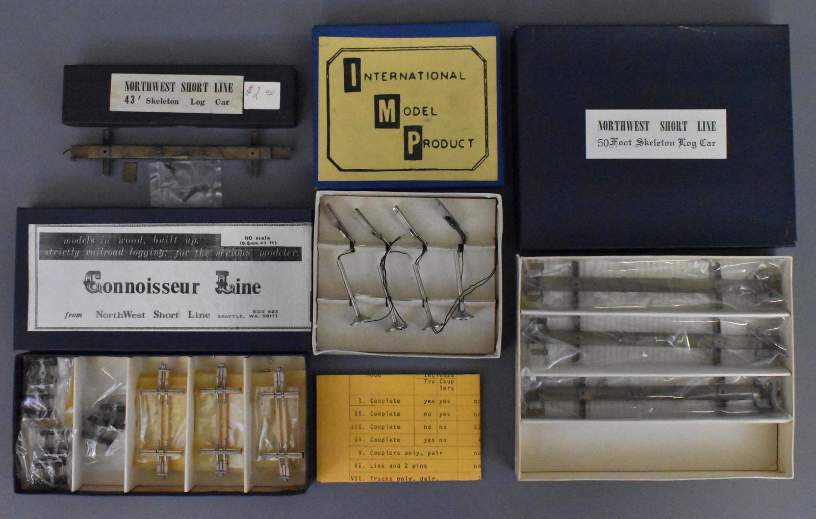 Group of four boxed kits Northwest Short Line HO Scale: Group includes Northwest Short Line 50 Foot Skeleton Log Car set of 4 in original box with one missing, brass is unused but C7 due to toning, 1 Northwest Short Line 43' Skeleton Log Car in original bo