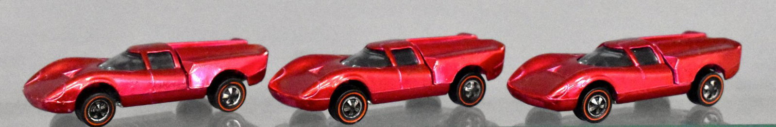 Group of 3 Rose Mattel Hot Wheels Redlines Lola GT70: Group includes 3 rose Lola GT70's in good condition with minor scattered fleas on all, all have tarnished bases and need wheel upgrades.