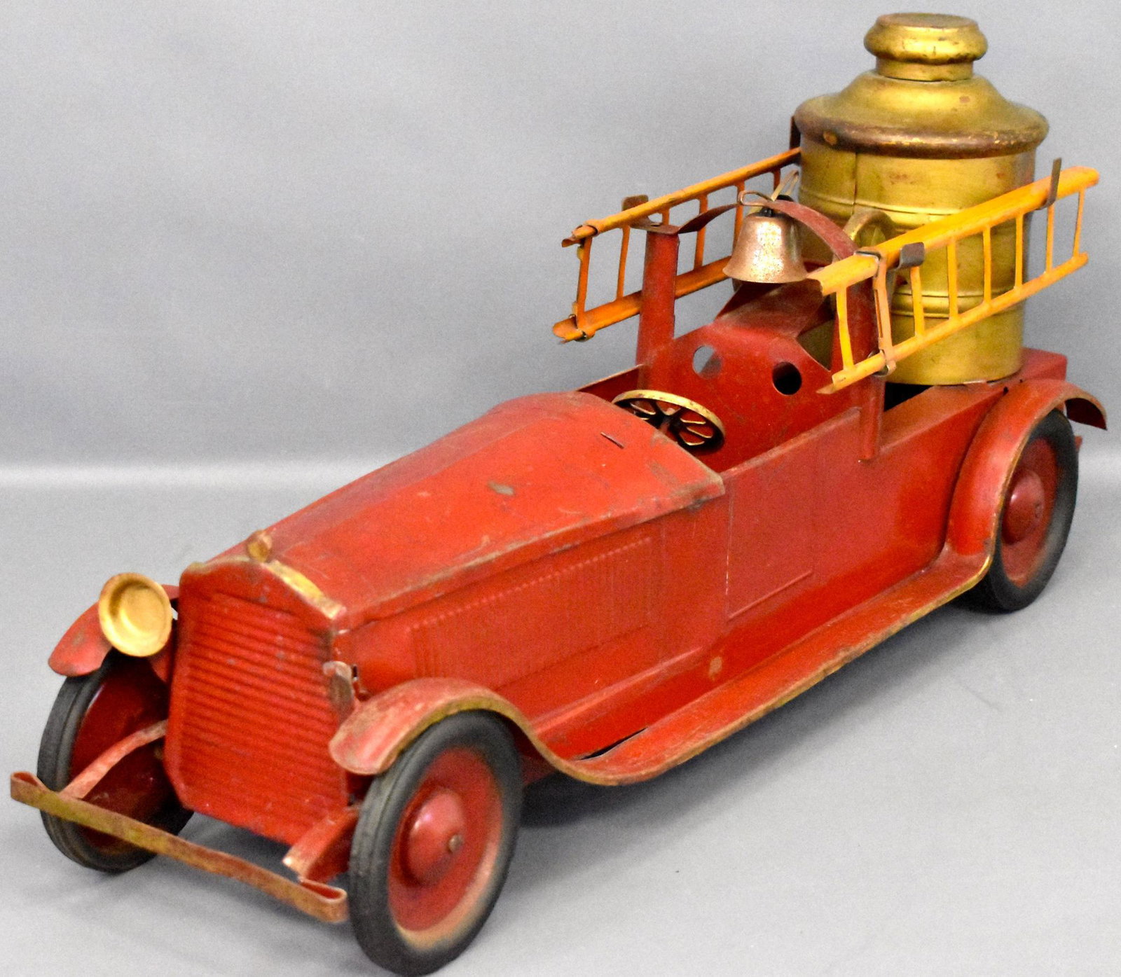 1920's Turner pressed steel fire pumper truck: 1920's Turner pressed steel fire pumper truck. Truck appears to be original paint, rubber wheels are still intact and good, missing the windshield and one headlight, comes with two ladders that may or