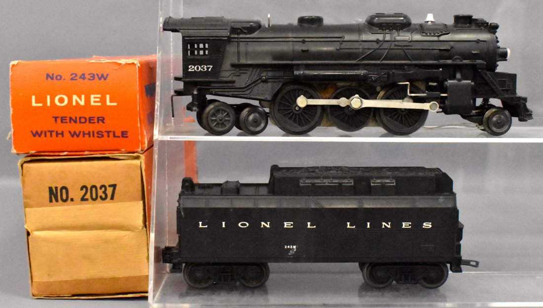 Lionel postwar O gauge 2037 steam locomotive and 243W t: Lionel postwar O gauge 2037 steam locomotive and 243W tender in original display boxes. Locomotive shows light run time and is very clean, C7+ with a very good perforated display box with 2018-14 slee