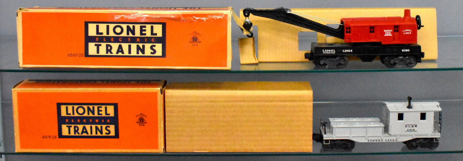 Lionel postwar O gauge 6419-25 6560-25 in original: Lionel postwar O gauge 6419-25 6560-25 in original boxes. Both show light run time and are C7 but the caboose has some chipping paint around the stack. The crane box is badly worn with a nice original