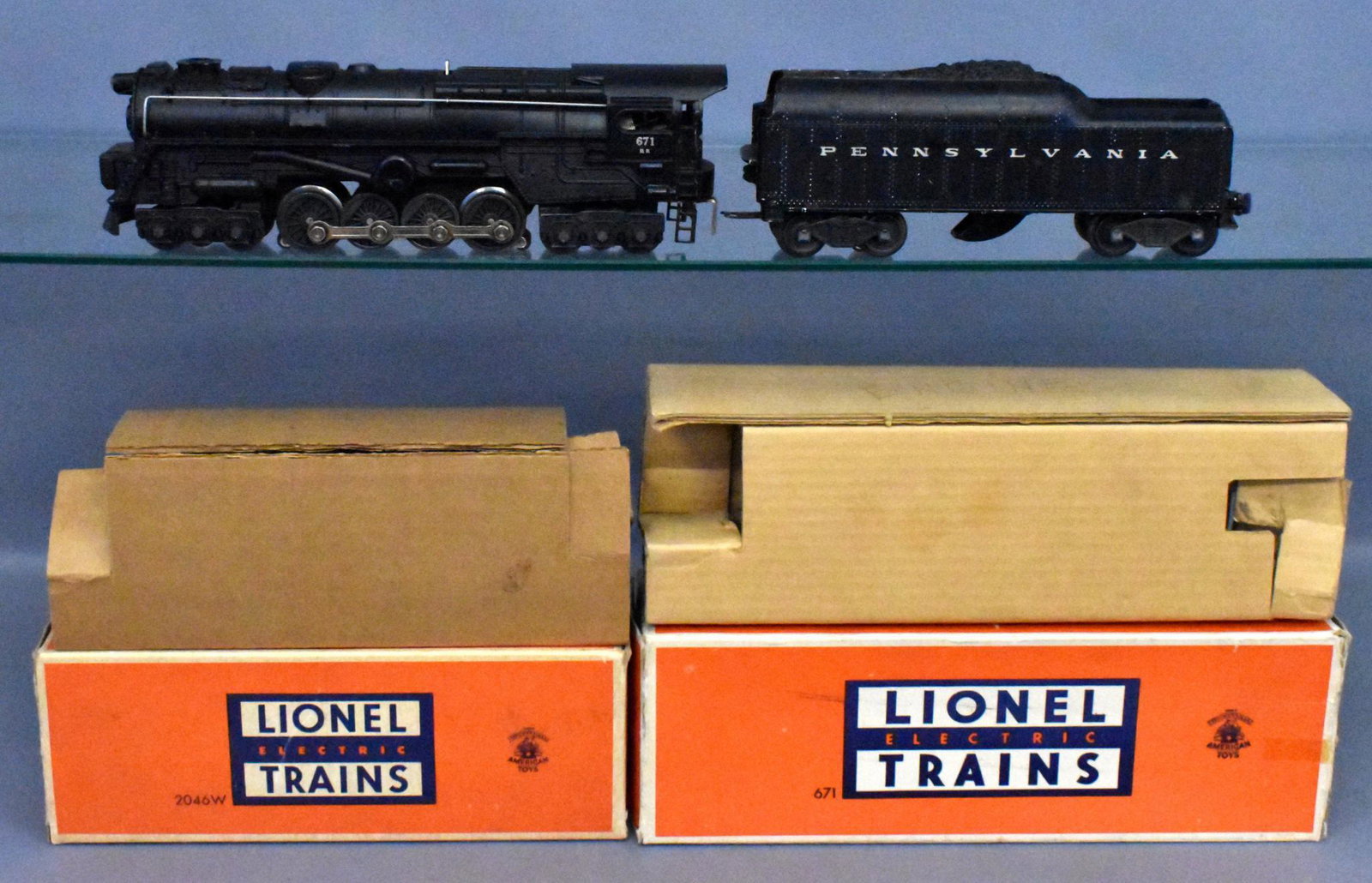 Lionel postwar O gauge 671RR steam turbine with 2046-50: Lionel postwar O gauge 671RR steam turbine with 2046-50 PRR tender in original boxes. Locomotive and tender show moderate run time but are clean. Locomotive is C7 with minor paint chipping, tender is 