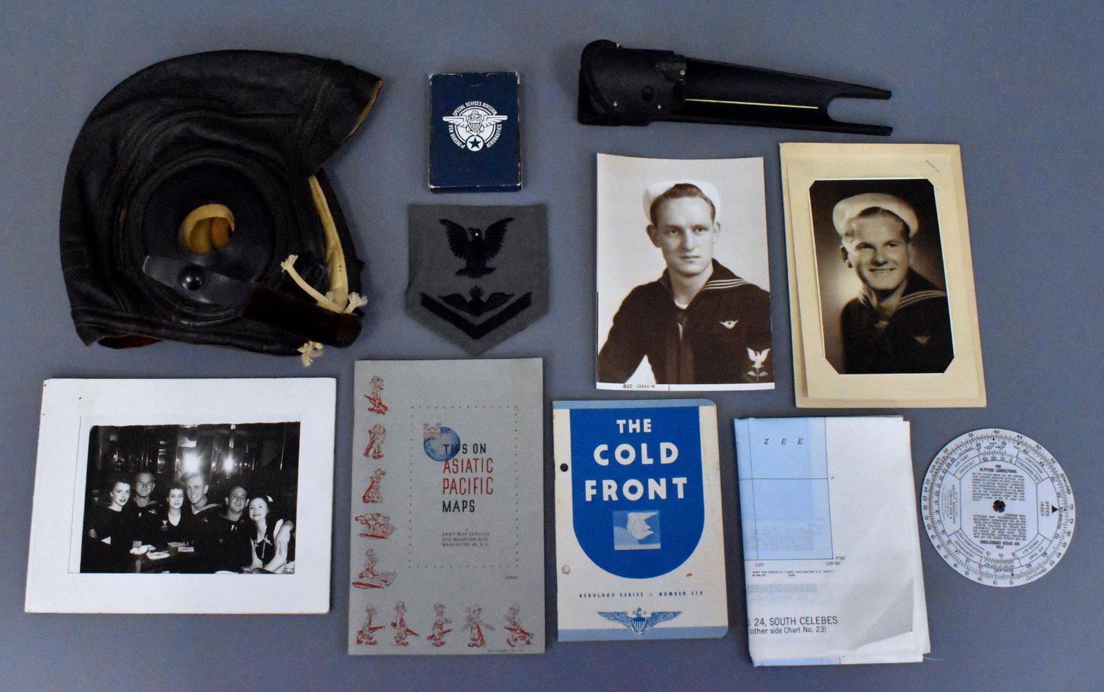 WWII US Navy pilot gun sight flight helmet cap: WWII US Navy pilot gun sight flight helmet cap navigation computer silk escape map. Lot includes what appears to be an aircraft gun sight, a mint Slote & Klein lamb skin leather USN flight helmet, air