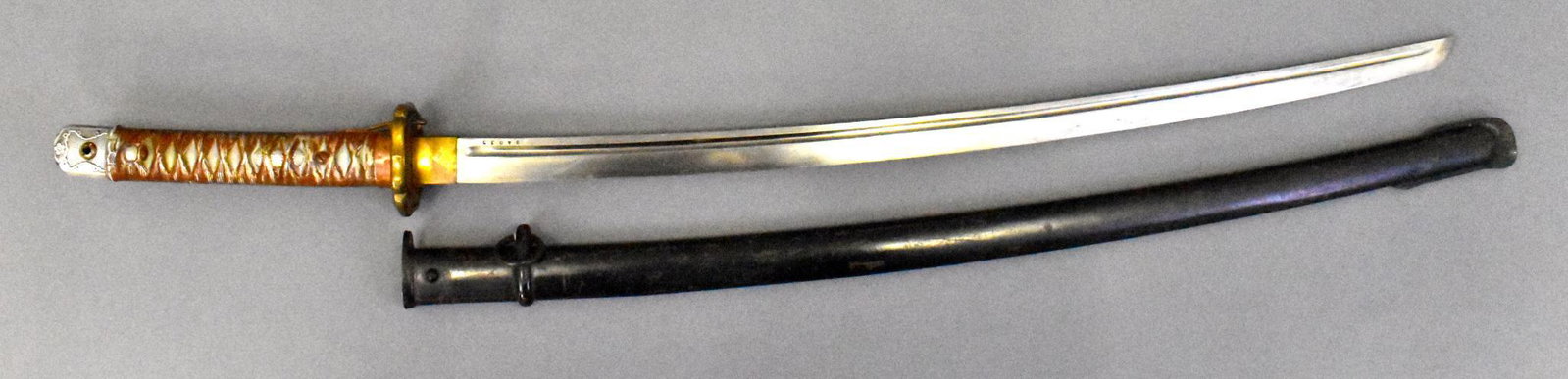 WWII Japanese military Type 95 NCO Sword Katana with: WWII Japanese military Army Type 95 NCO Sword Katana with scabbard. Aluminum handle and bronze Tsuba Variation 1. Overall very good to excellent condition. Excellent blade. Scabbard is painted black w