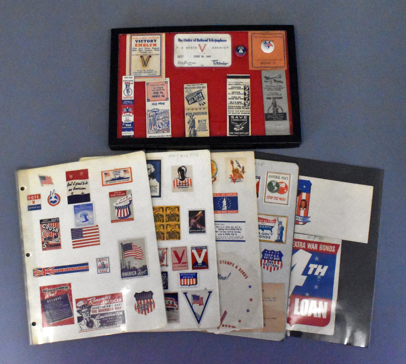 US WWII military home front Victory propaganda items: US WWII military home front Victory propaganda items. Riker frame with pins, buttons and match books along with 8 pages of stamps rockers and paper items. Many rare pieces in this group.