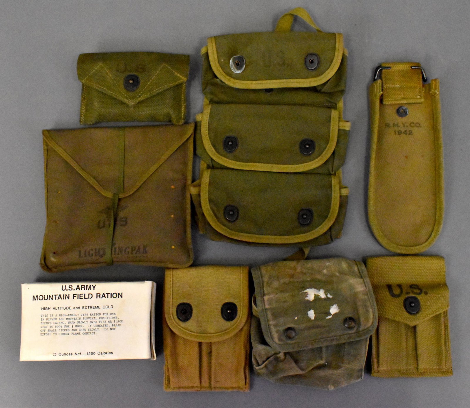 WWII US military equipment lot of web gear first aid: WWII US military equipment lot includes Carlisle bandage with 1944 pouch, wire cutter pouch 1942, 1918 and a 1942 Colt 1911 pistol magazine pouches, three pocket grenade pouch 1944, Empty jungle first