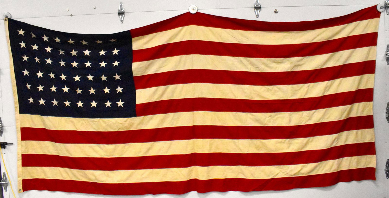 US WWII era 6 x 10 ft & 34 x 51 48 star flag: US WWII era 6x10 ft & 34 x 51 inch 48 star flags Large flag has some minor paint splatter small flag has been hemmed on reading edge and shows some wear.