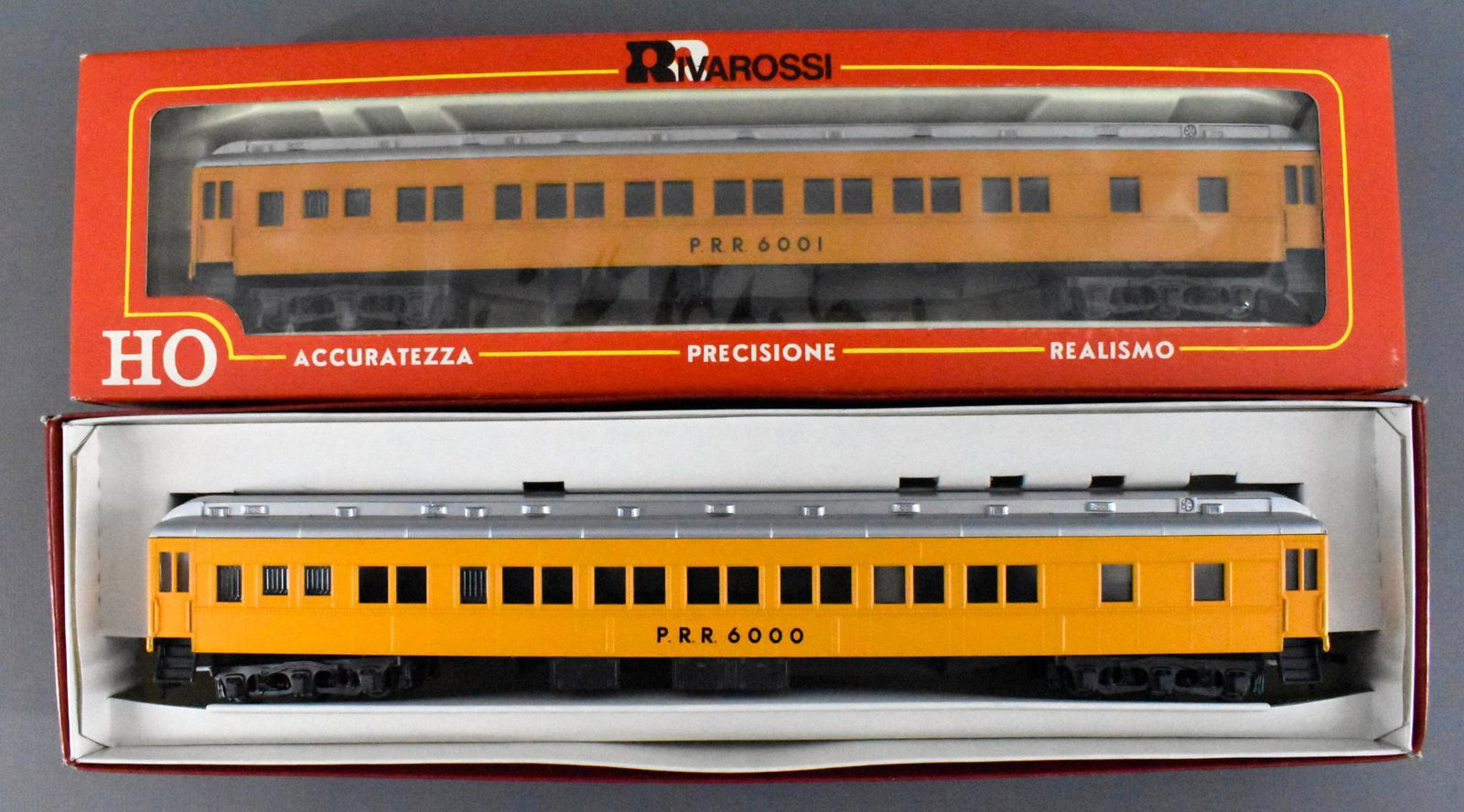 Two Rivarossi HO scale Pennsylvania MOW work train: Two Rivarossi HO scale Pennsylvania Maintenance of Way work train passenger cars in original boxes. Includes two Pullman cars numbered 6000 and 6001, both C9-10 in excellent original boxes.