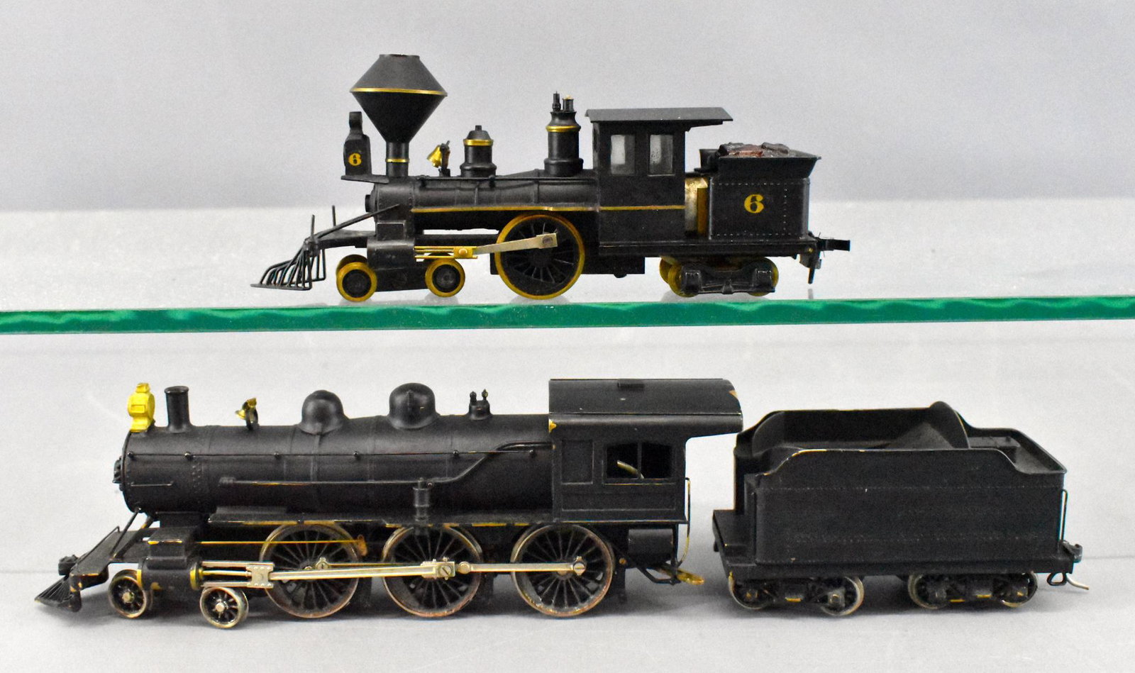 Two old time HO scale brass steam locomotives CP: Two old time HO scale brass steam locomotives to include a 4-2-4T CP Huntington and a 4-6-0 steam locomotive and tender, both only marked Japan. The Huntington is C7, the 4-6-0 is C6 and was painted b