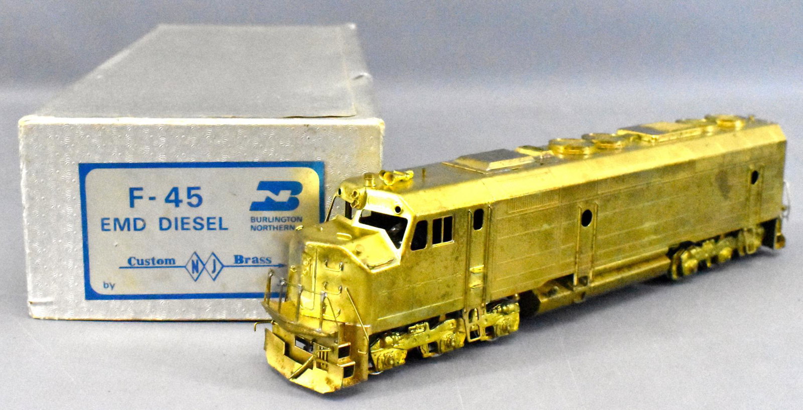 NJ Custom Brass HO Brass BN F-45 EMD Diesel OB: NJ Custom Brass HO Brass Burlington Northern F-45 EMD Diesel in original box. Locomotive is very clean and looks unrun but is C7 due to heavy toning. Box is fair but solid with no inserts or instructi