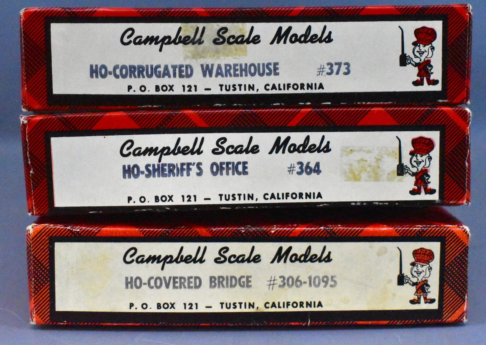 Three Campbell Scale Models HO Building kits in OB: Three Campbell Scale Models HO Building kits in original boxes, Kits include #73 Corrugated Warehouse, #306-1095 Covered Bridge, and #364 Sheriff's Office, all are unbuilt in very good original boxes.