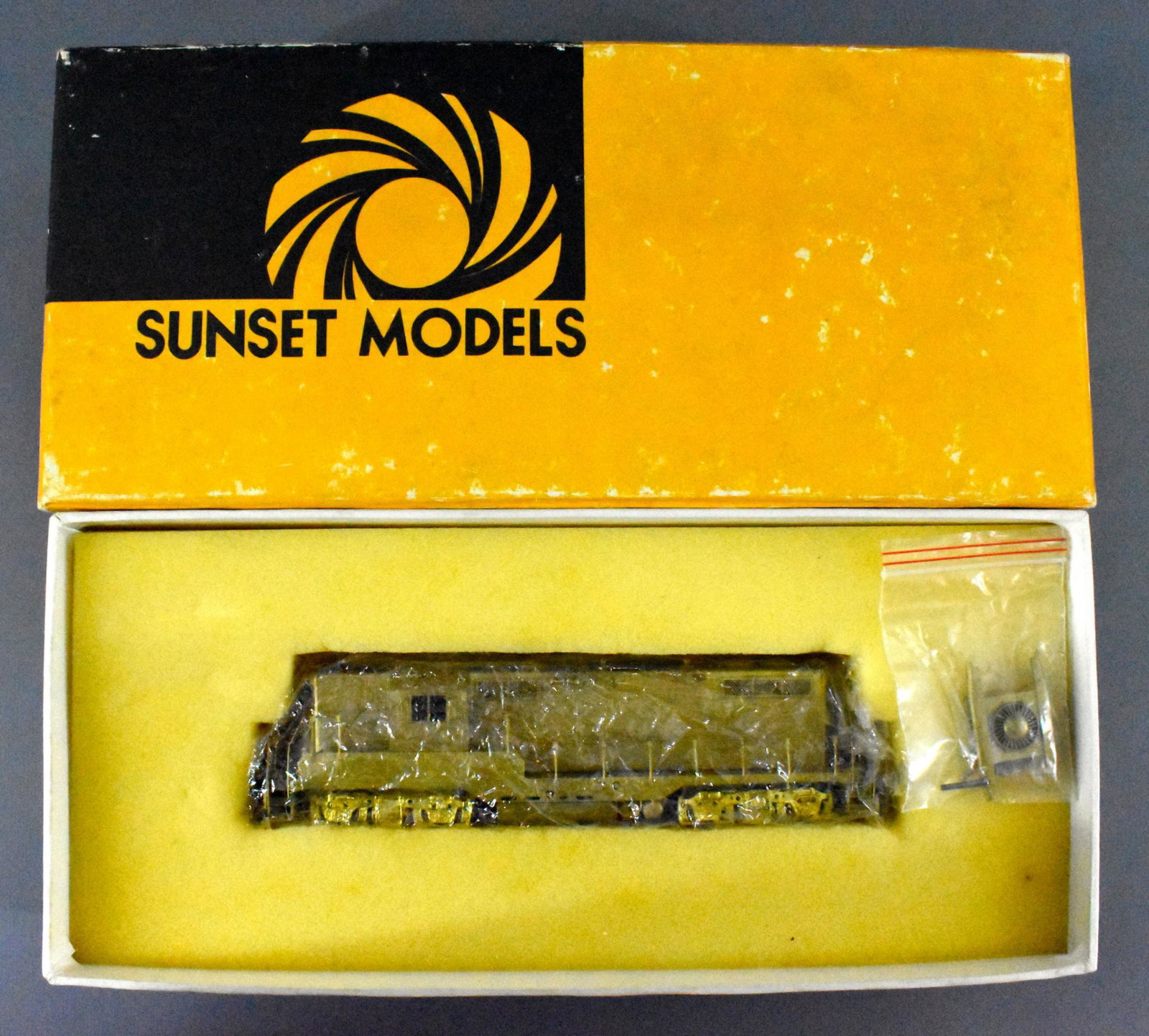 Sunset Models HO Brass EMD GP7 in OB: Sunset Models HO Brass EMD GP7 1500 HP Road Switcher in original box, unfinished unrun, C7-8 due to toning, in very good original box.