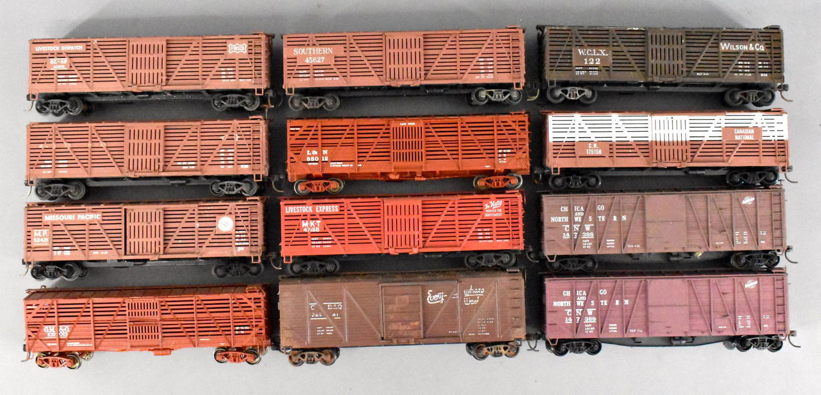 Twelve HO mixed road Cattle & Box cars loose: Twelve HO mixed road Cattle & Box cars loose. Group includes 2 wood sided North Western box cars, 1 CB&Q wood sided box car, and 9 cattle cars of mixed road names. All are used in very good or better