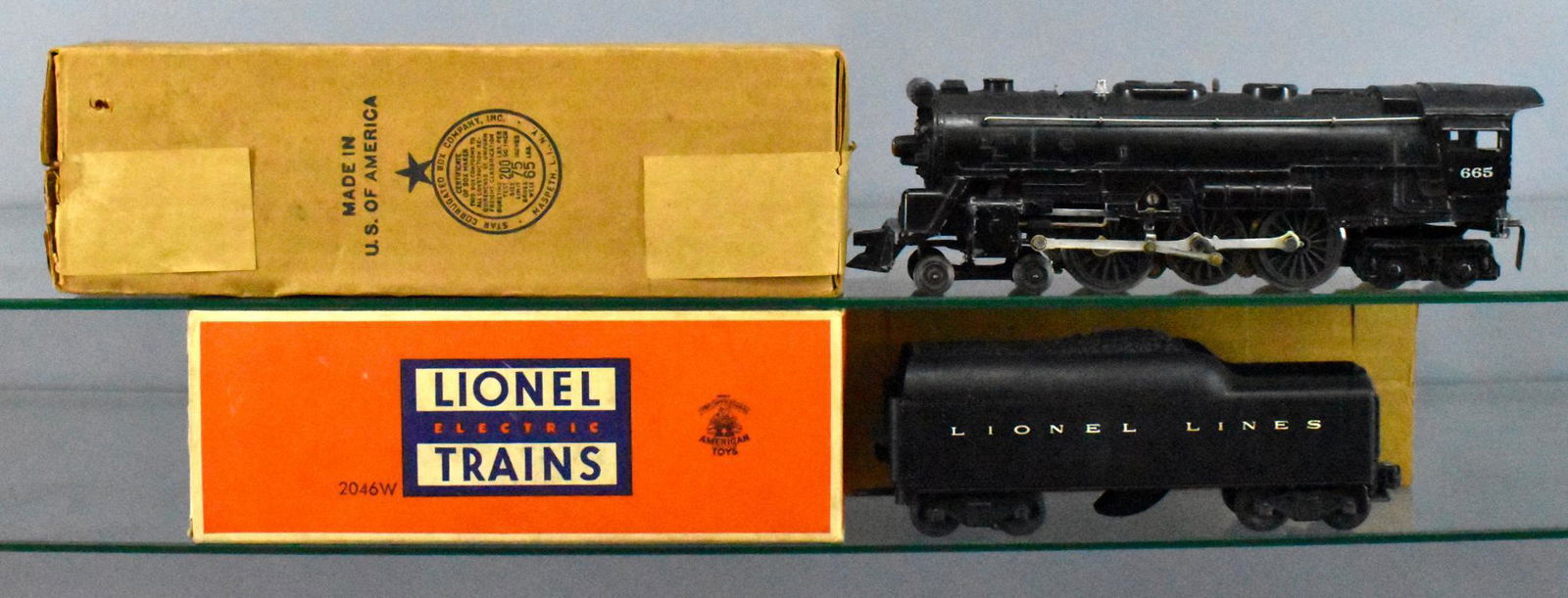 Lionel postwar O 665 steam locomotive and 2046W tender: Lionel postwar O 665 steam locomotive and 2046W tender in original boxes. Locomotive is C6-, tender is C6+, the original boxes are good to very good condition.