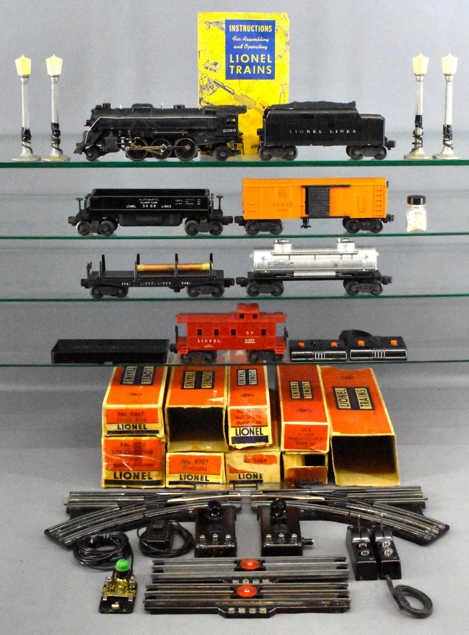 Lionel postwar O 1453WS steam freight set and extras: Lionel postwar O 1453WS steam freight set and extras. Includes 2026 steam locomotive with smoke, 6466 WX Tender, 6465 tank car, 3469X automatic dump car, 3461 automatic lumber car, 3464 operating box 