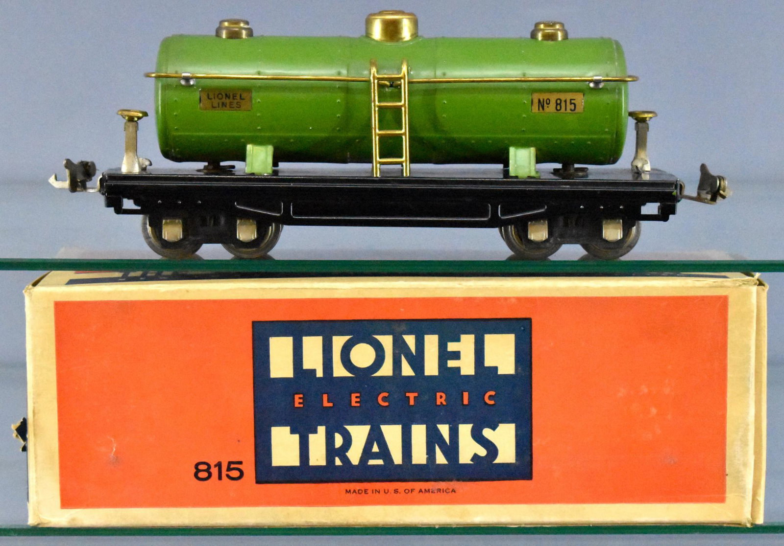 Lionel prewar O gauge 815 tank car with incorrect: Lionel prewar O gauge 815 tank car with incorrect original box. Car shows moderate run time but is very clean with little paint loss but does have tarnish on the brass handrails, also has nickel journ