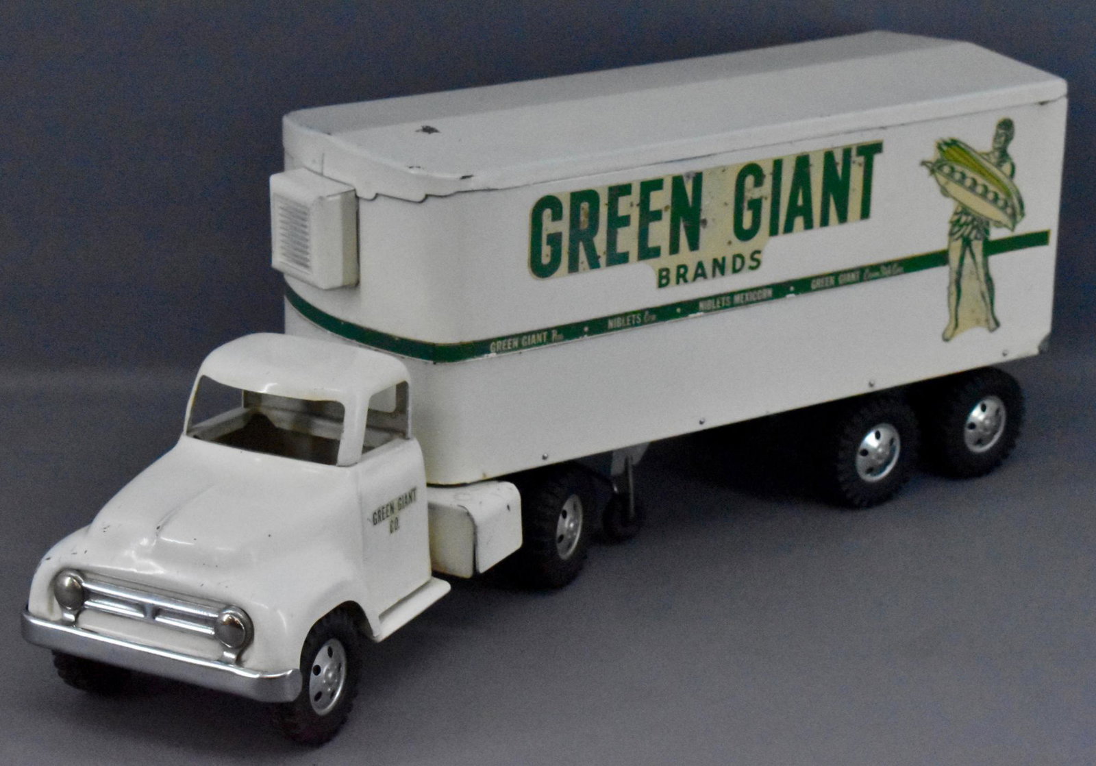 1954 Tonka pressed steel Green Giant semi tractor: 1954 Tonka pressed steel Green Giant semi tractor trailer, all original and clean with some play wear and visible scratches, especially around the hitch area, otherwise displays very nicely.