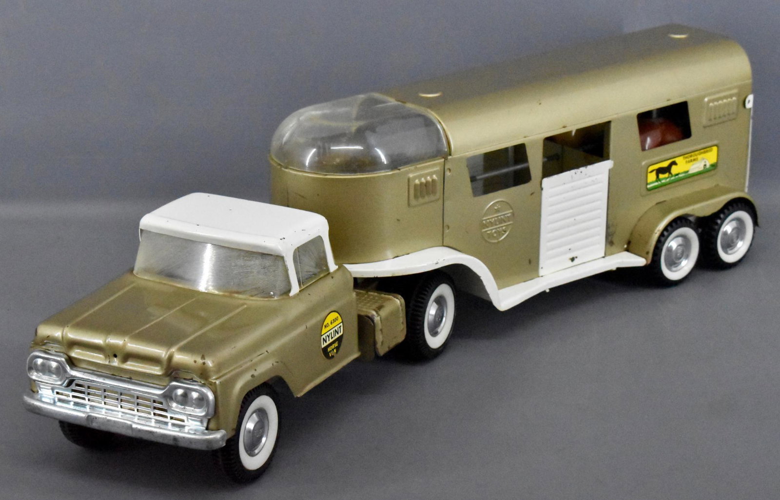 1960 Nylint pressed steel #6300 horse van: 1960 Nylint pressed steel #6300 horse van, shows play wear and scratches is complete and all original with one minor crack in the vista dome glass. The windshield is crazing but intact as seen in the 