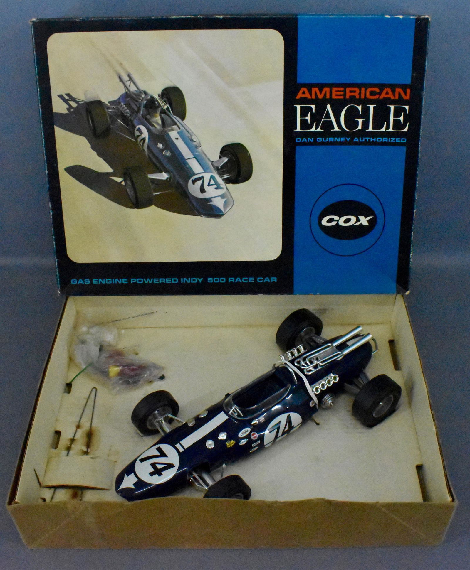 Cox 1/12 scale Dan Gurney American Eagle gas racer: Cox 1/12 scale Dan Gurney American Eagle gas tether car in original box, never run but decals have been applied and still look nice. Comes with small parts, wrench and original paperwork. The original