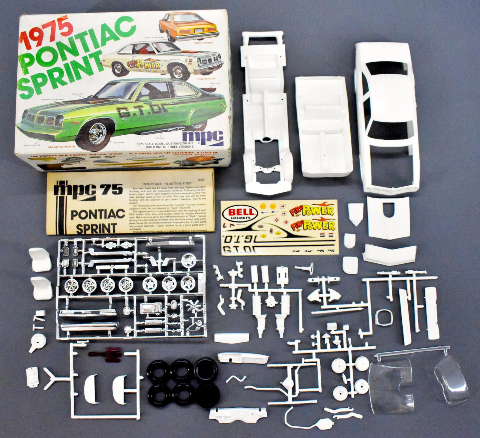 Unbuilt MPC 1975 Pontiac Ventura Sprint 1/25 scale: Unbuilt MPC 1975 Pontiac Sprint 1/25 scale model kit 7503. Kit appears to be complete and has some pieces loose from the sprues, a crisp original instruction sheet and mint unused decal sheet in an ex