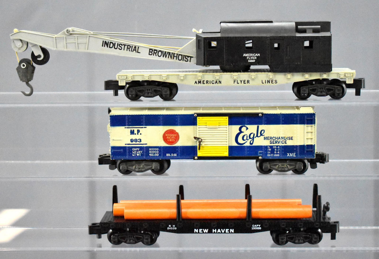 Three American Flyer S gauge freight cars 983 24539: Three American Flyer S gauge freight cars to include 983 Missouri Pacific box car with a chipped catwalk end, 24539 New Haven flat car with three original pipes and 24569 Brownhoist crane car, C7 unle