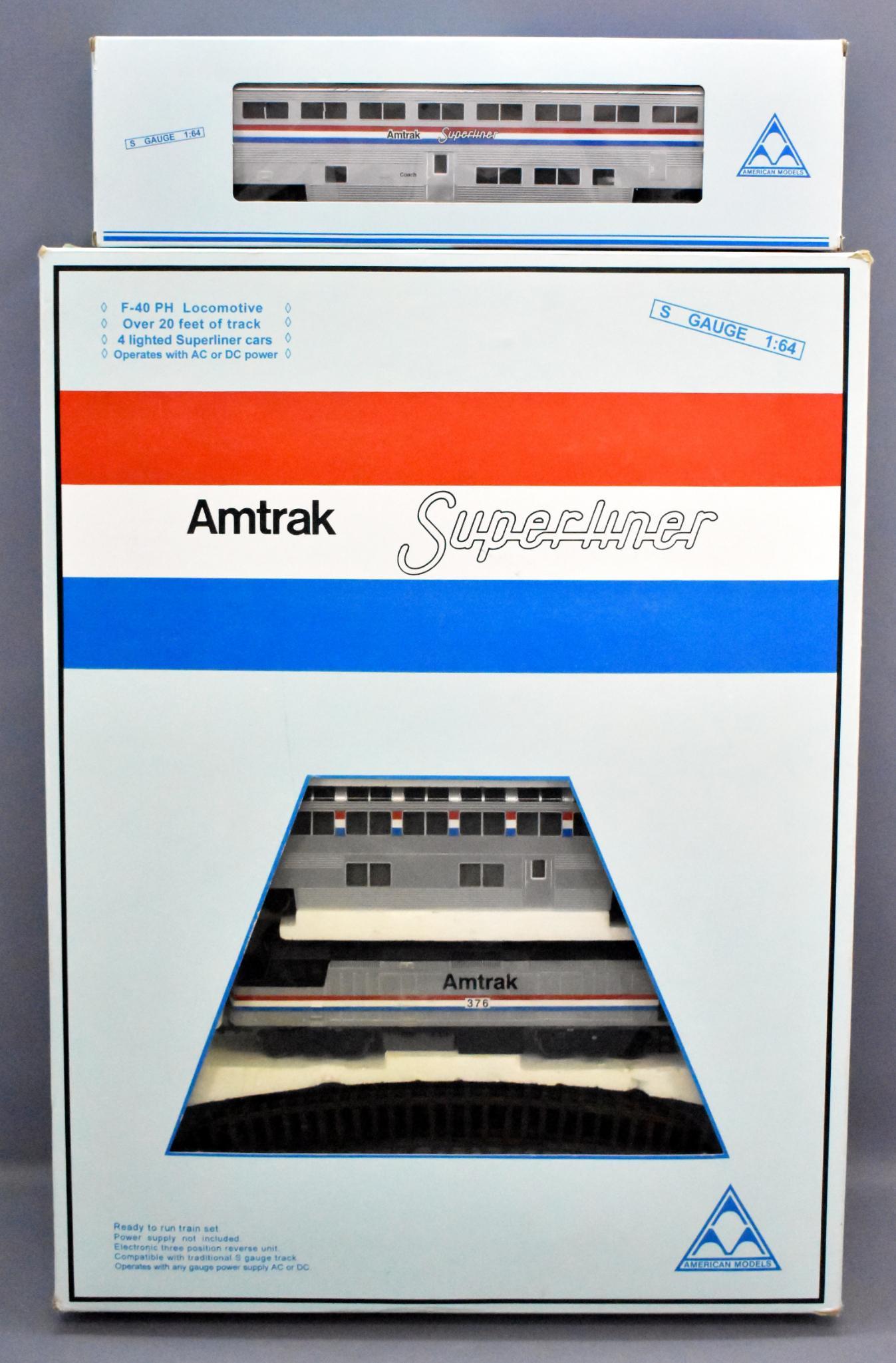 American Models S gauge hi-rail Amtrak superliner train: American Models S gauge hi-rail Amtrak superliner train set in original box plus an add-on car. Trains show light run time but the diesel unit has a piece broken off of the pilot on the left side and