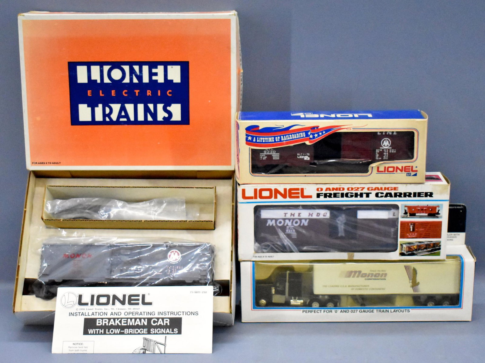 Group of Lionel O gauge Monon freight cars in original: Group of Lionel O gauge Monon freight cars in original boxes to include 9230 box car, 9218 mail delivery car, 19811 operating brakeman car and 12783 die cast tractor trailer, all C8 in good original b