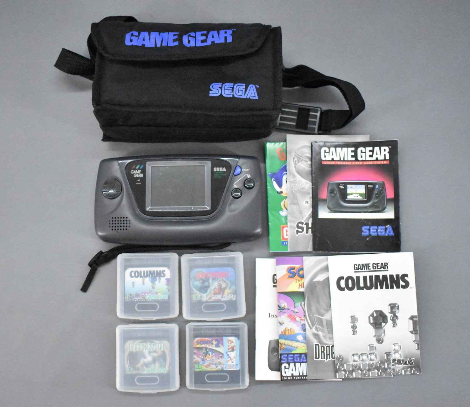Sega Game Gear with four games and case: Sega Game Gear with four games and case. Game was tested with four new AA batteris and does not work. Does not have an adapter. Comes with Columns, Shinobi, Drago Crystal andSonic the Hedgehog 2, all 