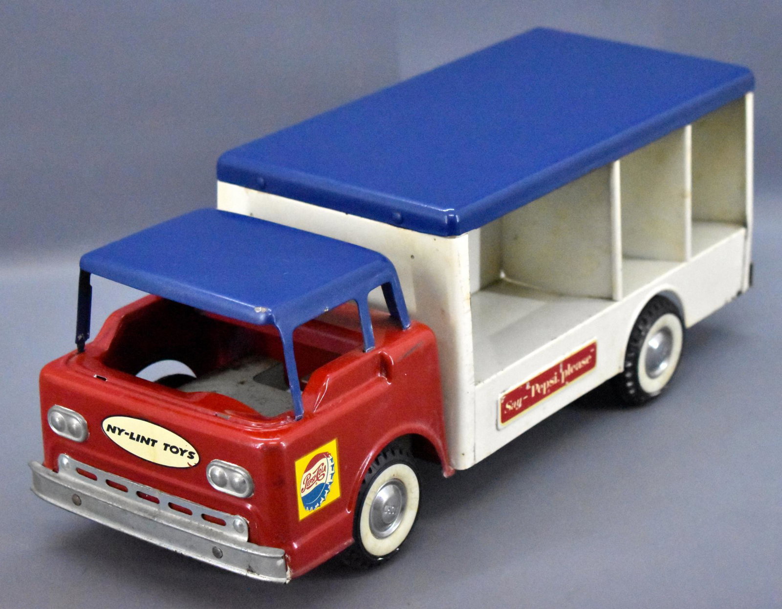 Nylint pressed steel Pepsi delivery truck: Nylint pressed steel Pepsi delivery truck, has some minor paint wear and is missing the windshield and all of the Pepsi crates, measures 16 1/4" long.