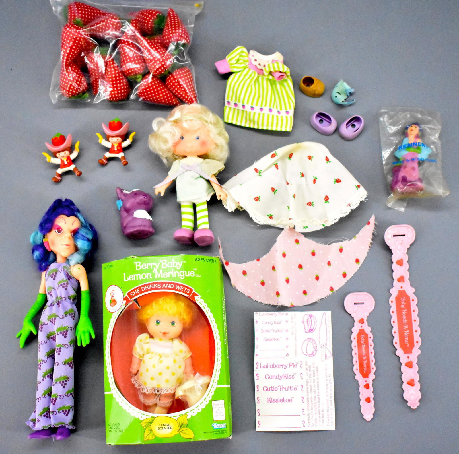 Group of Vintage Strawberry Shortcake Dolls: Group of vintage 80's Strawberry Shortcake dolls, the Berry Baby Lemon Meringue is mint in an excellent sealed box, also includes a loose Sour Grapes and a loose Angel cake & souffle, plus misc access