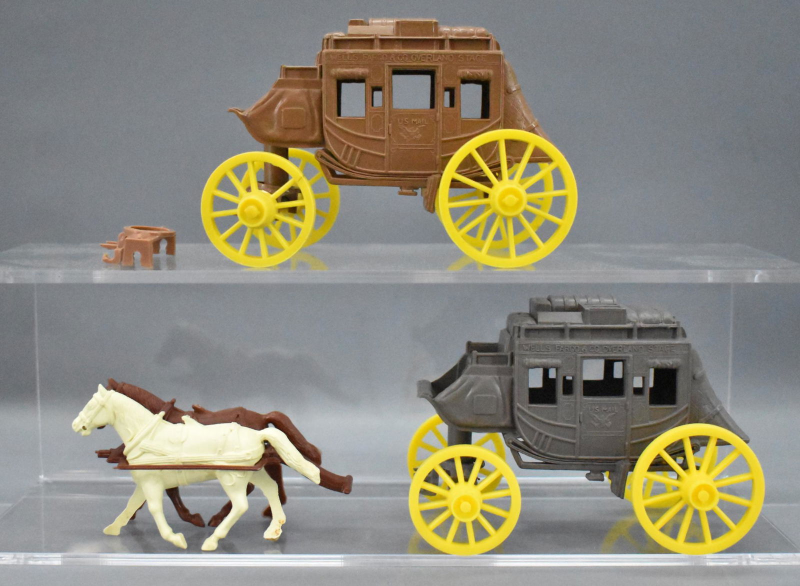 Original and recast Marx Wells Fargo Overland Stage: Original and recast Marx Wells Fargo Overland Stage Coach wagons. The original coach is missing two small tabs where the harness clips in, otherwise very nice. The recast piece is in excellent conditi