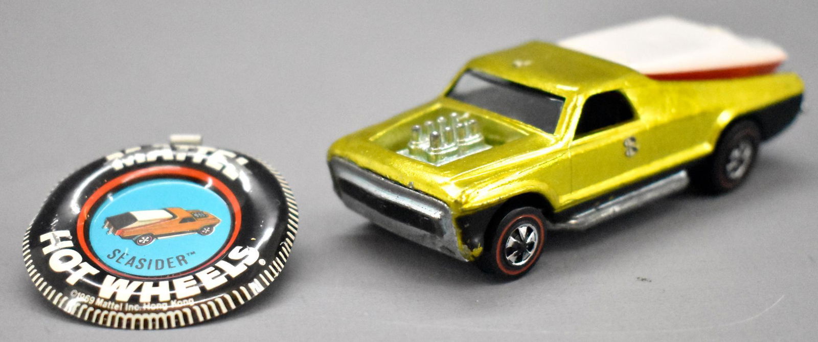 Redline Hot Wheels yellow US Seasider with original: Redline Hot Wheels yellow Seasider with original button and boat, super clean and shiny with kid applied decals on roof and both sides and a dull base plus an original button.