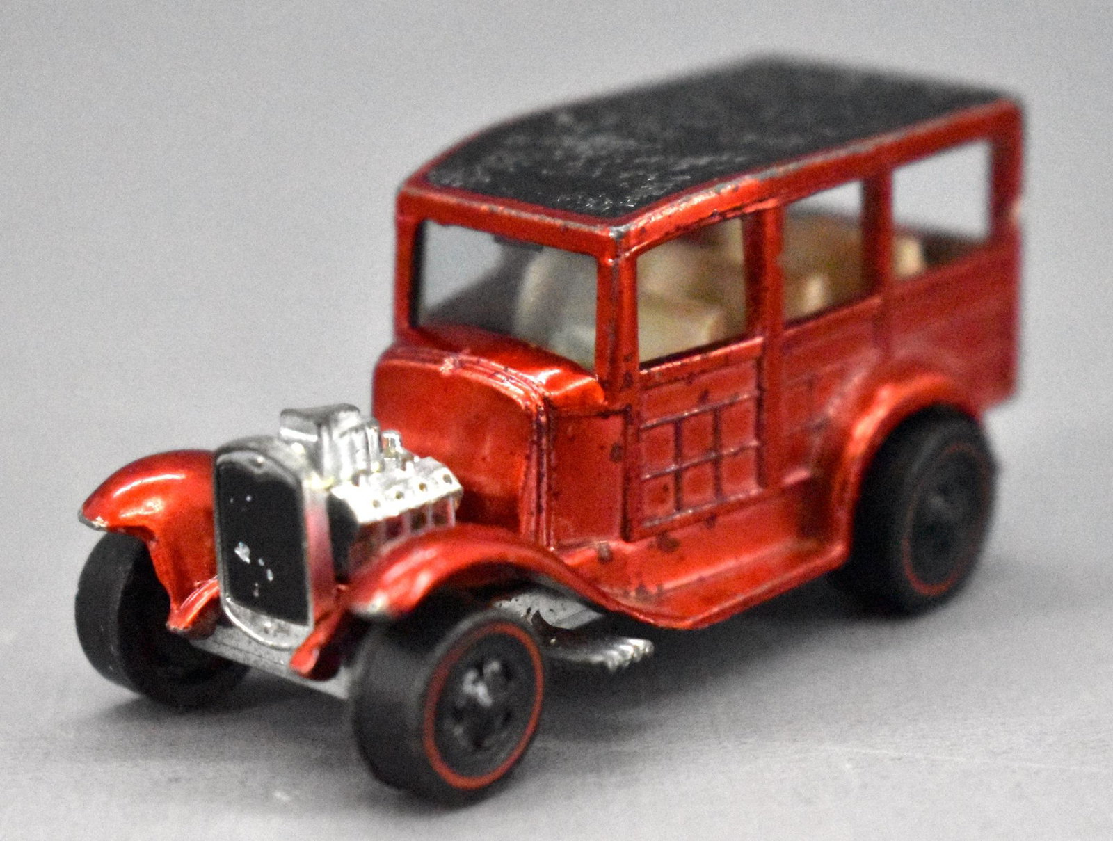 Redline Hot Wheels faded red Classic '31 Ford Woody: Redline Hot Wheels faded red Classic '31 Ford Woody, very clean but is missing all of the wheel chrome on the drivers side wheels and has a dull base.