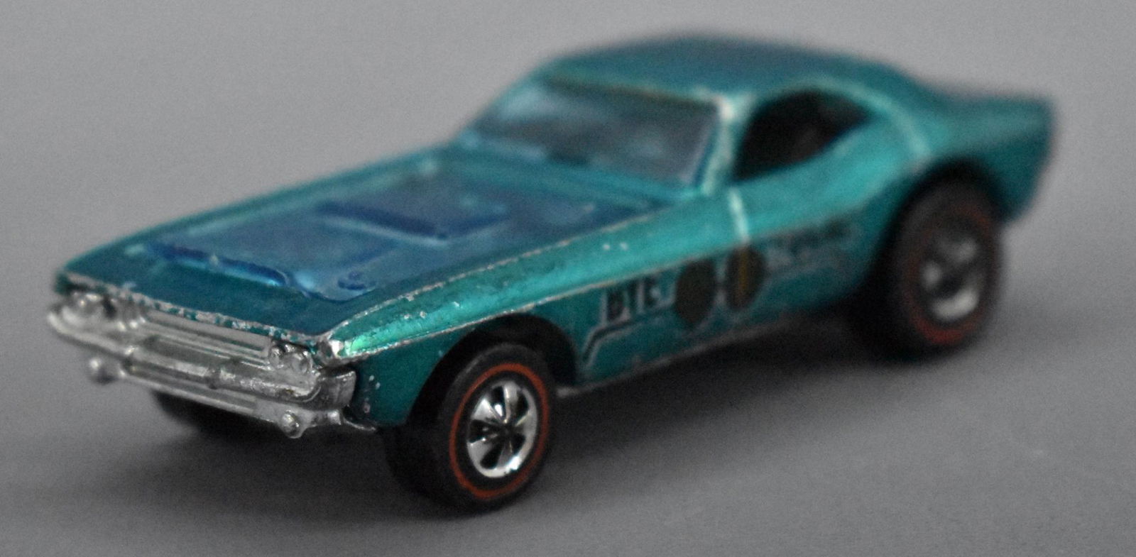 Redline Hot Wheels aqua Bye Focal: Redline Hot Wheels aqua Bye Focal with clear blue hood, car is clean with nice decal on the drivers side and slightly faded or worn decal on the opposite side, some paint loss on high edges and a shin