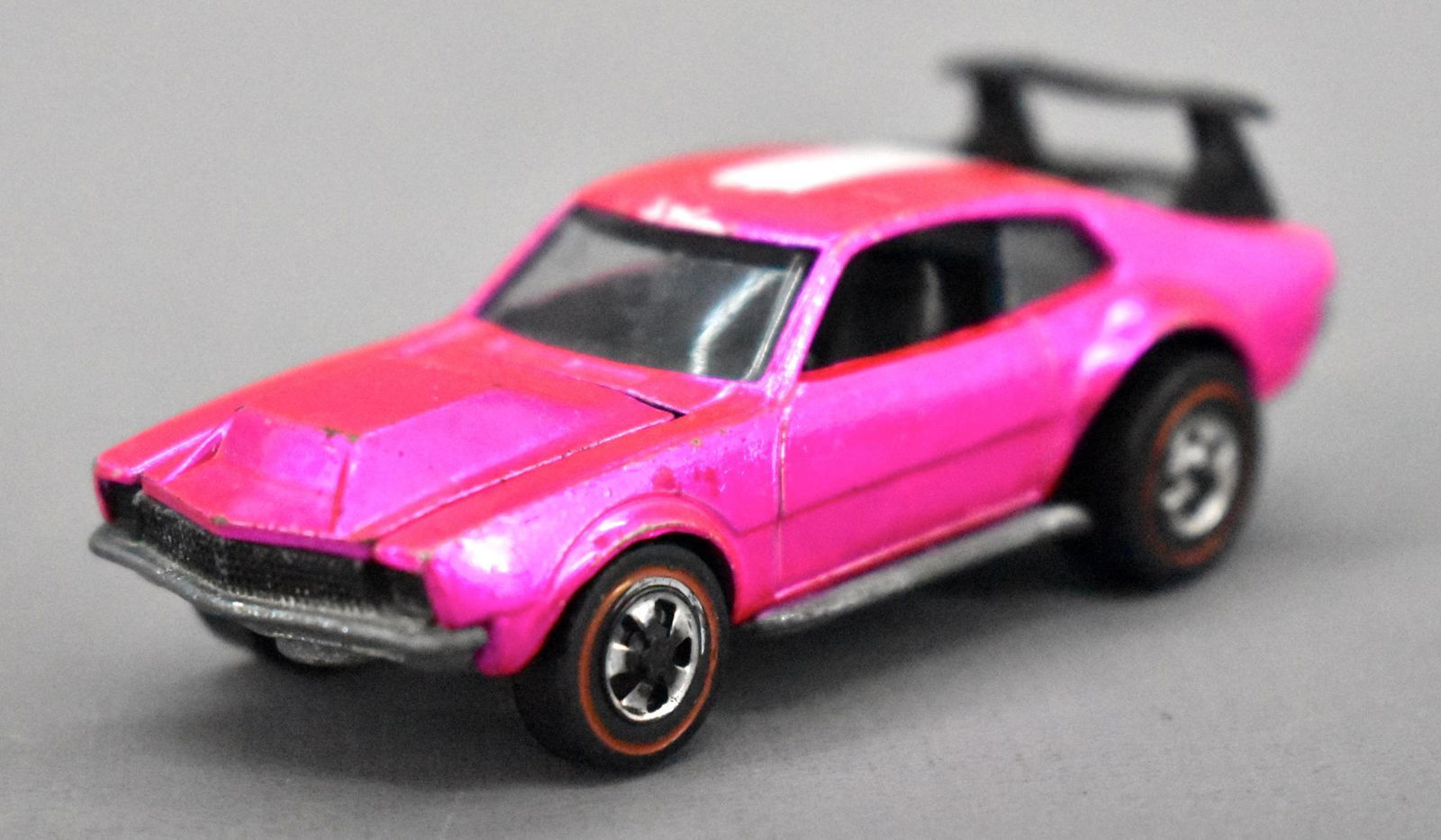 Redline Hot Wheels hot pink US Mighty Maverick: Redline Hot Wheels hot pink US Mighty Maverick, very clean car with minimal paint wear, some roof stripe loss and missing the back half of the wing and has some chrome loss from the wheels with a dull