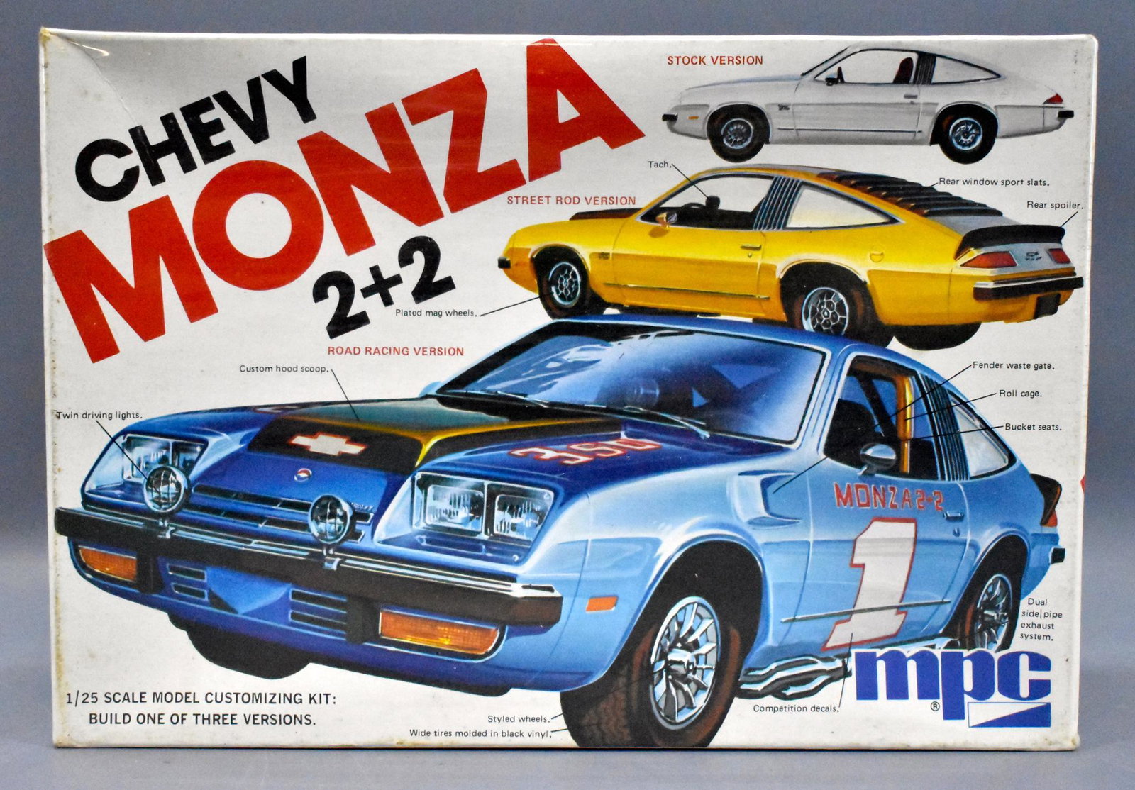 Factory sealed MPC 1975 Chevy Monza 2 + 2 1/25 scale: Factory sealed MPC 1975 Chevy Monza 2 + 2 1/25 scale model kit 7516, very nice with a slightly sunken in lid but great color and a K Mart price sticker for $1.97 on one end.