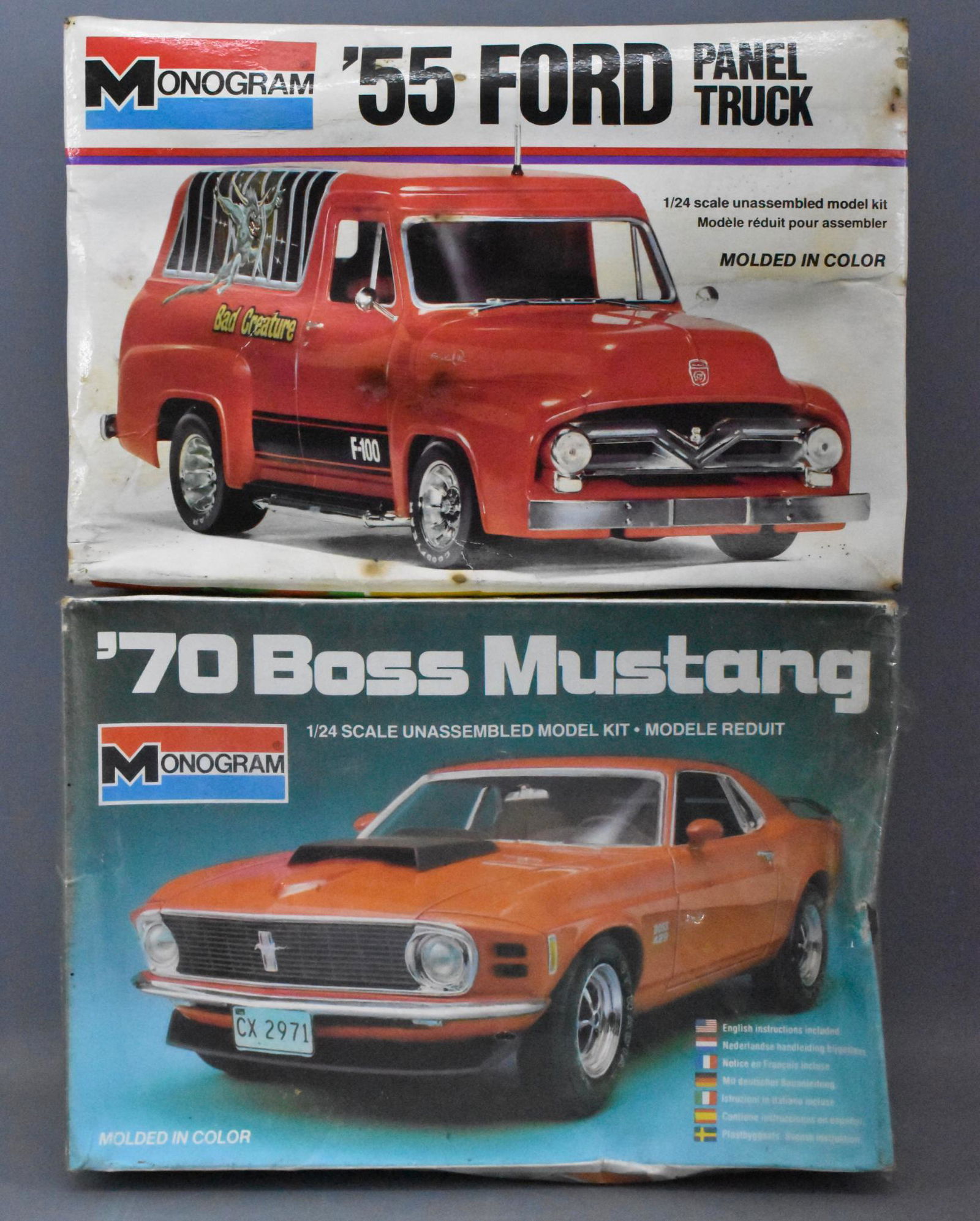 Two Ford 1/25 scale model kits in original boxes: Two Ford 1/25 scale model kits in original boxes to include a factory sealed Monogram 1/24 scale model kit in original box '70 Boss Mustang and an open box, sealed bag '55 panel truck with water damag