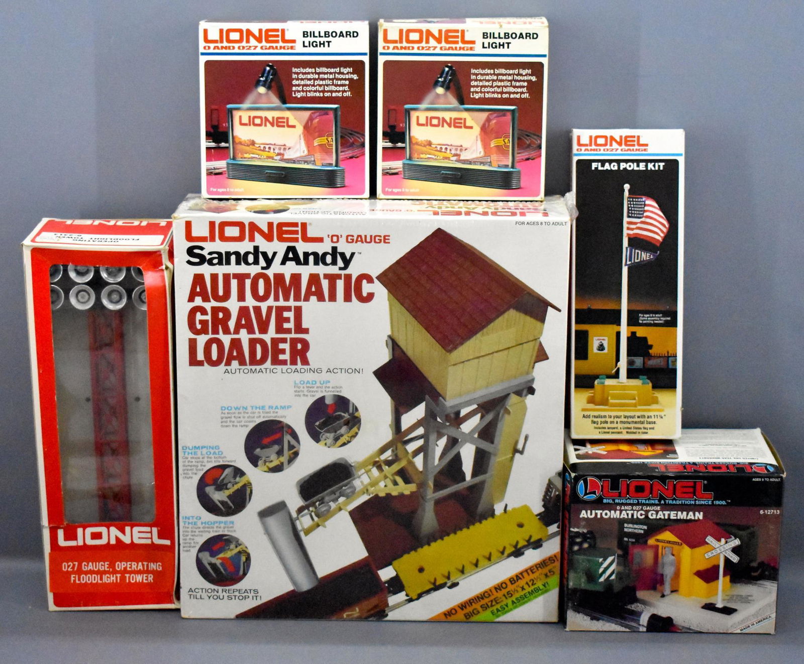 Group of Lionel modern era O gauge train layout: Group of Lionel modern era O gauge train layout accessories in original boxes to include a factory sealed 2175 Sandy Andy automatic gravel loader, 2320 flag pole kit, two 2307 billboard lights, 12713