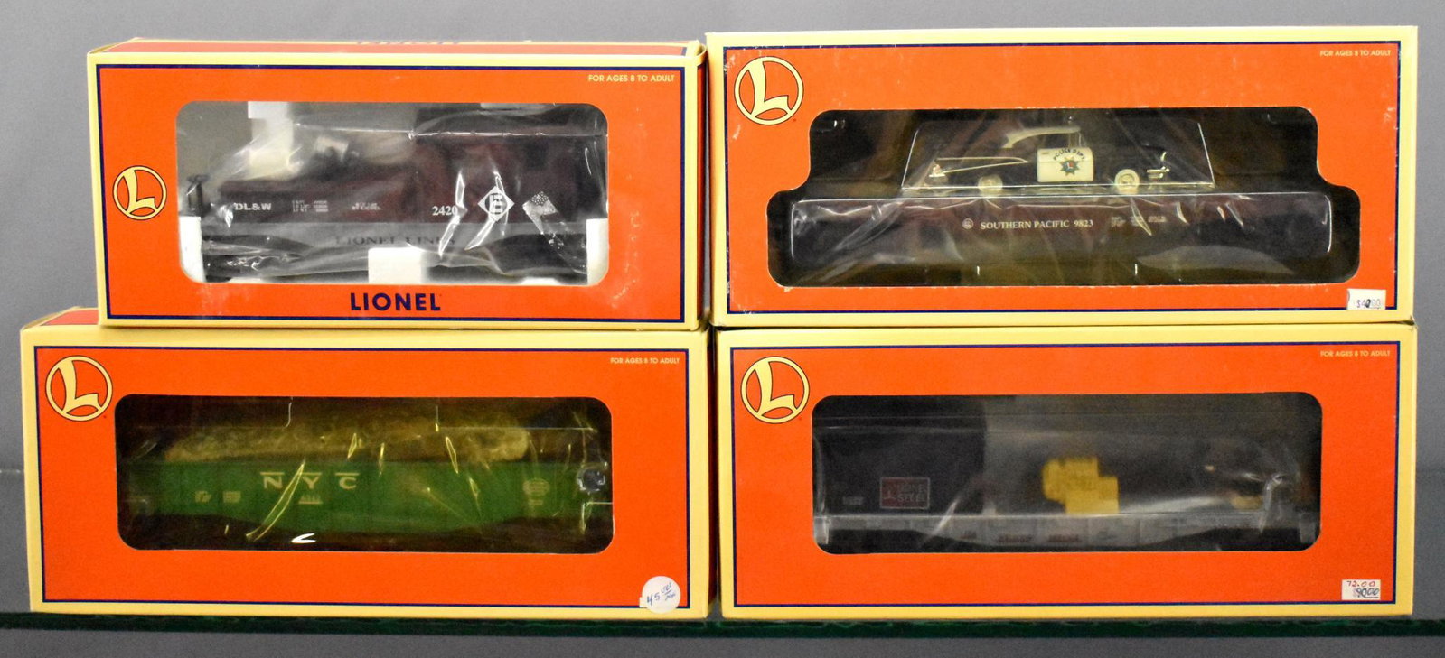 Four Lionel modern era O freight cars in original boxes: Four Lionel modern era O freight cars in original boxes to include 19737 2420 Lackawanna searchlight caboose, 26906 Southern Pacific flat car w/ '57 Chevy police car, 19478 New York Central culvert go