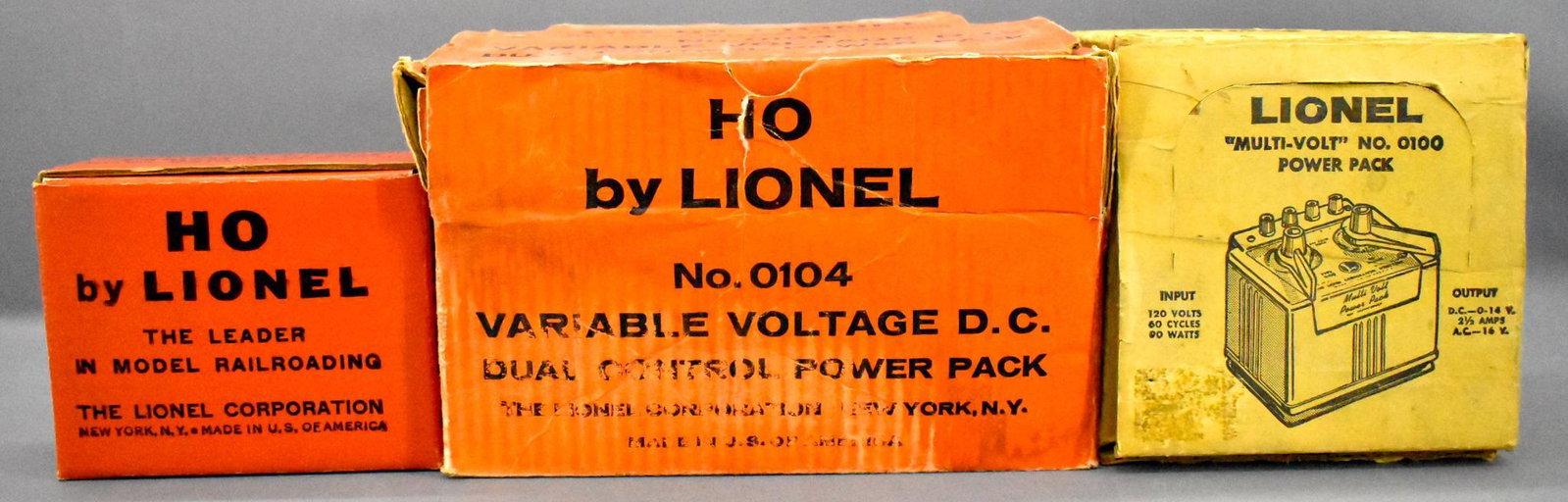 Three Lionel postwar HO transformers in original boxes: Three Lionel postwar HO transformers in original boxes to include 0104 variable DC, 0101 AC / DC with brittle cord and 0100 multi-volt power pack, C6 with good original boxes.