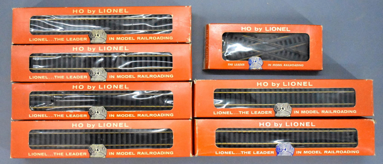 Lionel postwar HO straight track and crossings: Lionel postwar HO straight track and crossings to include six boxes of Lionel HO 0909 straight track plus three 0930 30 degree crossings in a dealer box.