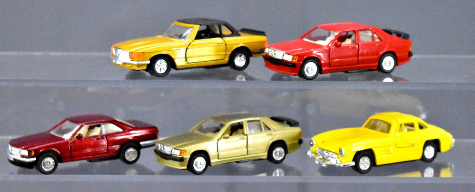 Group of five Chinese made Mercedes pull back cars: Group of five Chinese made Mercedes pull back cars, four work, one does not, 1/43 or about that size range.