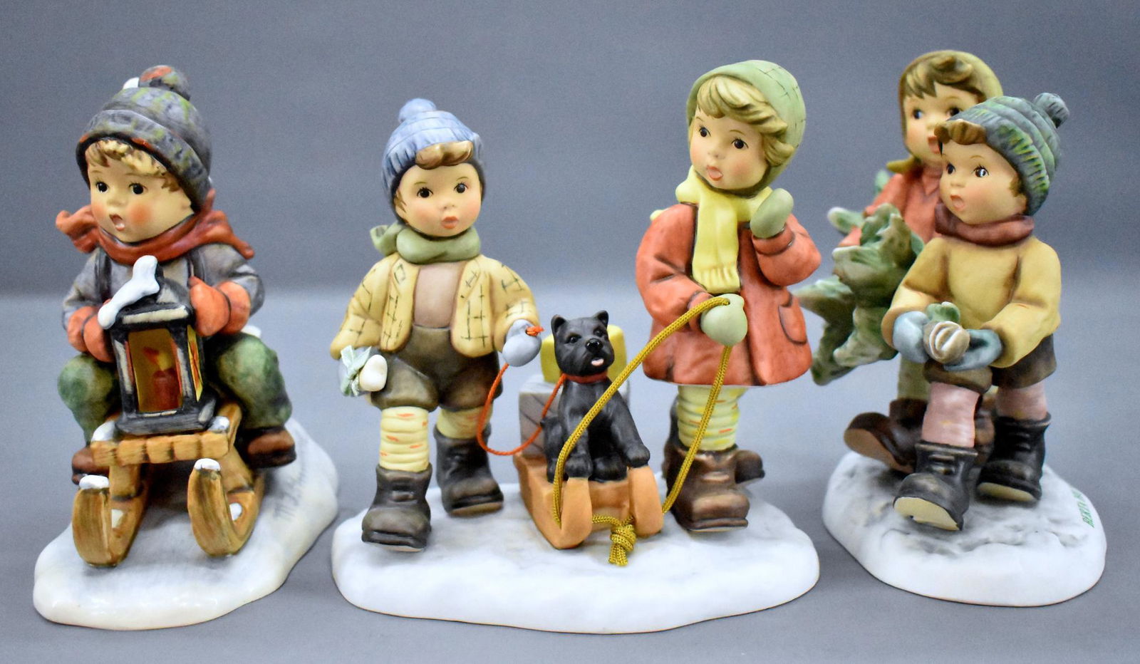 Goebel Hummel 396 Ride into Christmas plus two other: Goebel Hummel 396 Ride into Christmas plus two other scenes, BH-12 Tree Trimming Time and BH-60 Sledding Time (spelled incorrectly on the figurine as Sleeding Time). All three are near mint and damage