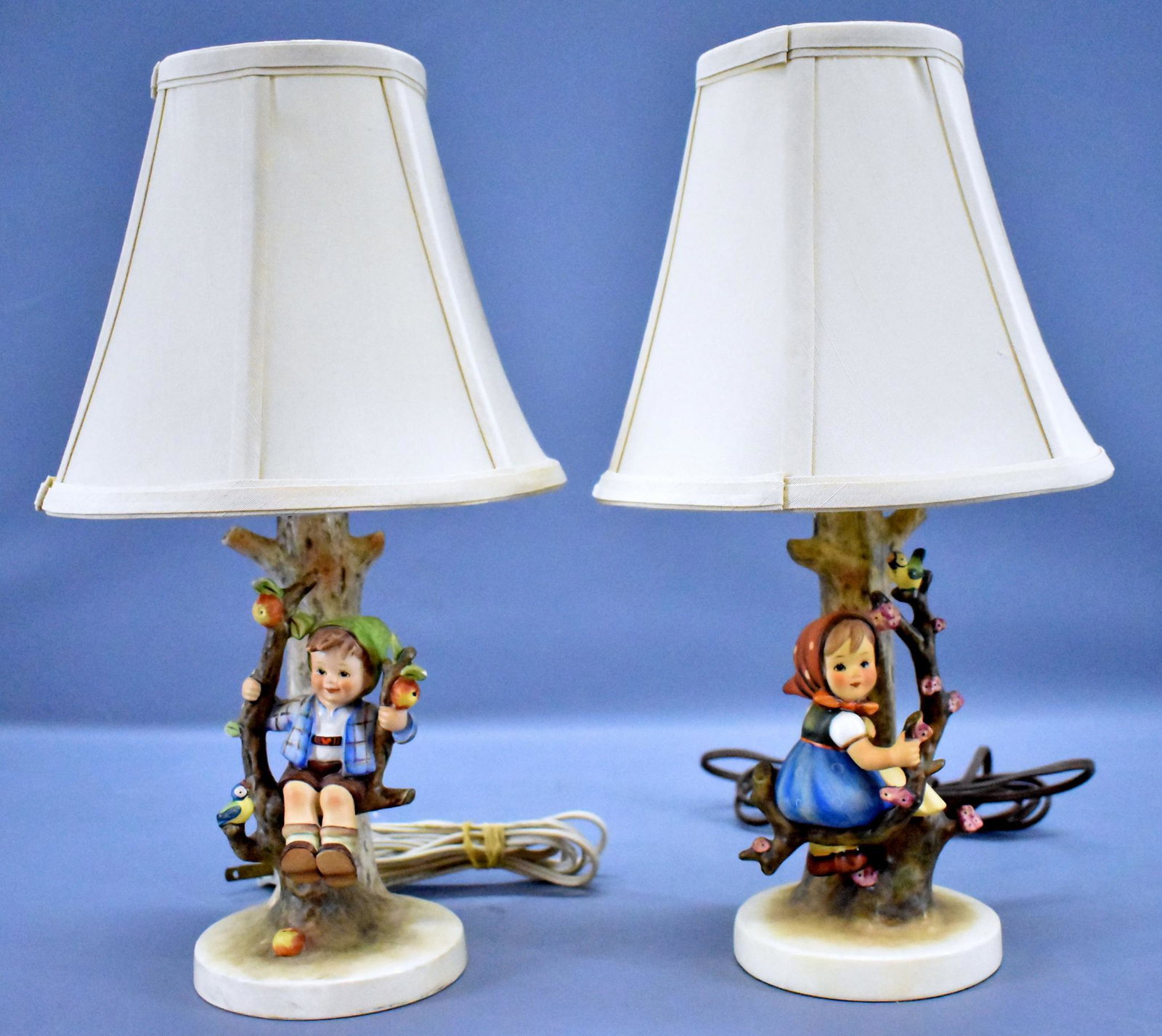 Hummel Apple Tree Boy / Girl electric lamps with shades: Hummel Apple Tree Boy / Girl electric lamps with shades. Both lamps are in excellent condition with no visible damage, the shades may or may not be original to the lamps, neither has been tested and b